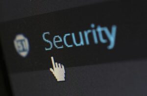 This image is a close up of a computer screen. The background is black and has a link that says Security with the mouse pointer about to click it.